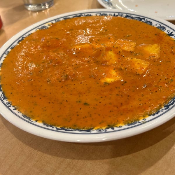 Tadka Indian Restaurant's paneer butter masala, a rich orange curry with paneer cheese cubes.